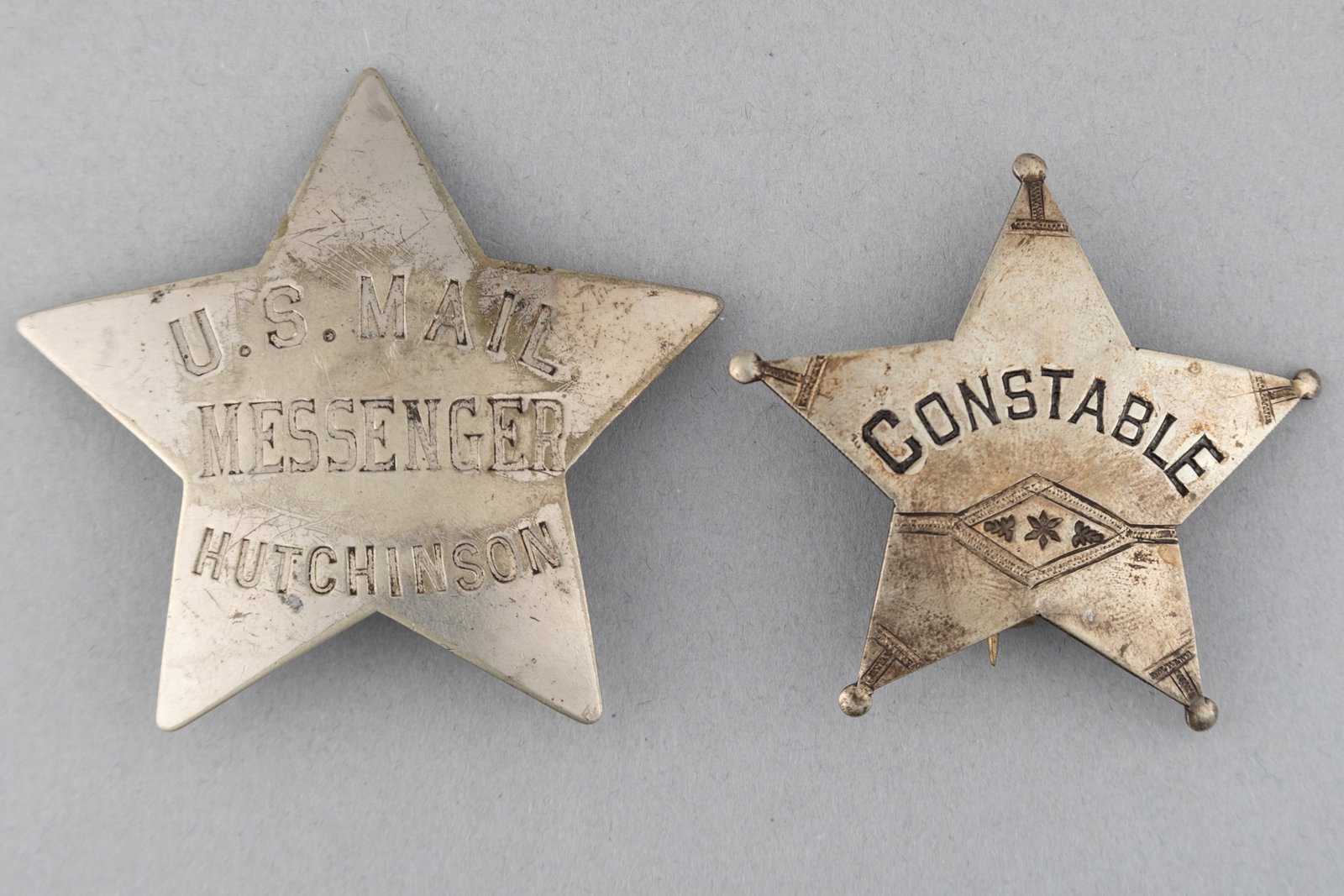 This lot consists of two Badges: (1) Constable 5-point ball star Badge, 2 1/8" across points, turn: This lot consists of two Badges: (1) Constable 5-point ball star Badge, 2 1/8" across points, turn of the century, possibly 1900. (2) U.S. Mail Messenger/Hutchinson 5-point star Badge, 2 5/8" across p