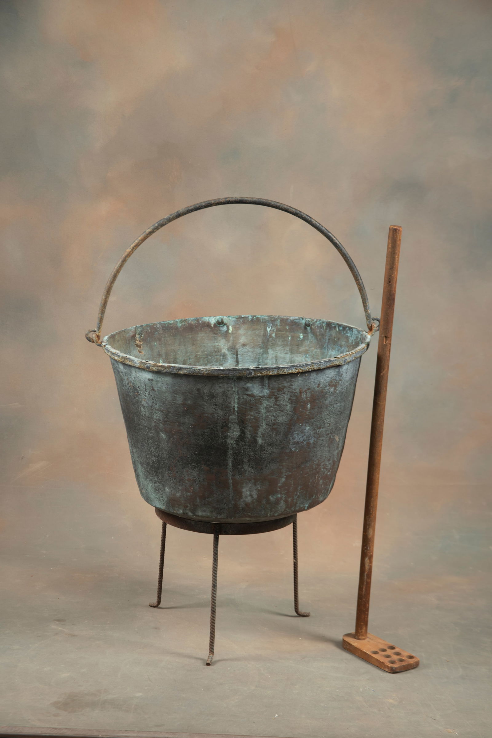 Antique copper Apple Butter Rendering Pot with blacksmith made iron handle and original wooden: Antique copper Apple Butter Rendering Pot with blacksmith made iron handle and original wooden paddle with holes for mashing. Pot measures 15" D x 22" dia., in original estate found condition. Sold wi