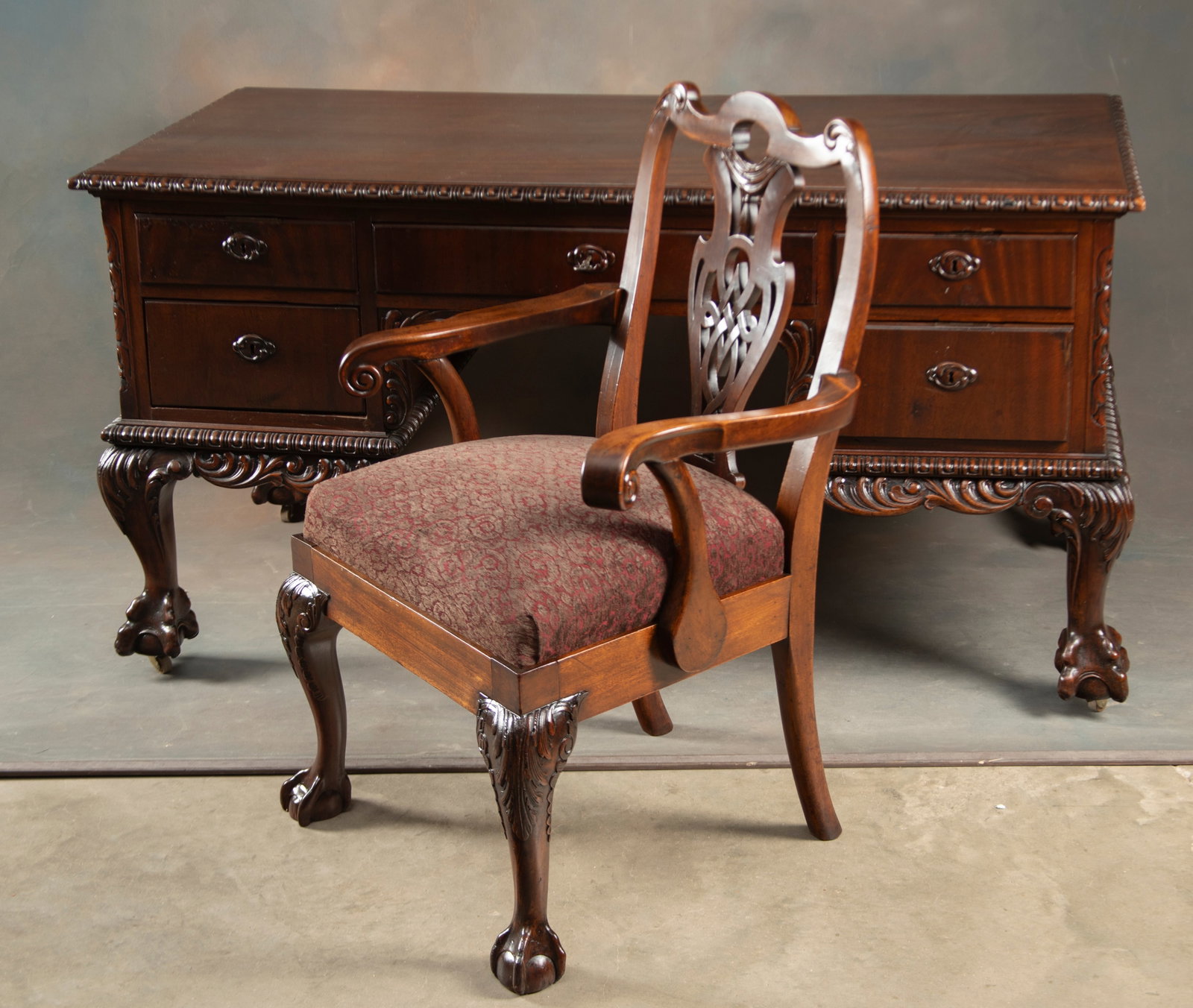 Highly carved vintage mahogany Flat Top Desk with carved claw feet and carved bordered top.: Highly carved vintage mahogany Flat Top Desk with carved claw feet and carved bordered top. Excellent finish and condition, measures 61" L x 30 1/2" D x 32 1/2" T. Sold with key. Desk is sold with a m
