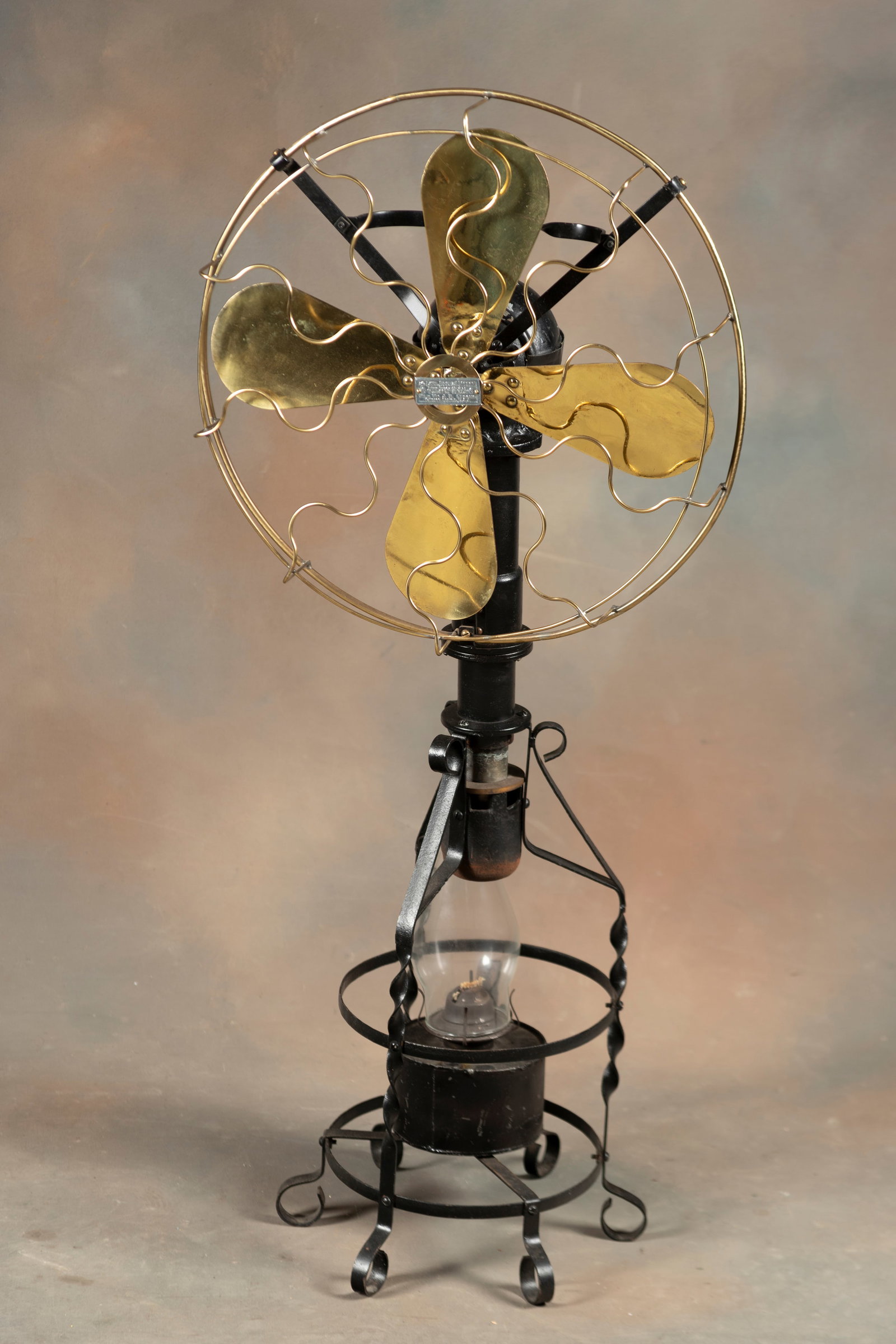 Very unique antique Floor Model Fan that runs off kerosene with large brass blades and cage. Label: Very unique antique Floor Model Fan that runs off kerosene with large brass blades and cage. Label reads "Lake Breeze Motor by William J.H. Strong, Chicago, Illinois." Fan stands 41" T with 18" cage a