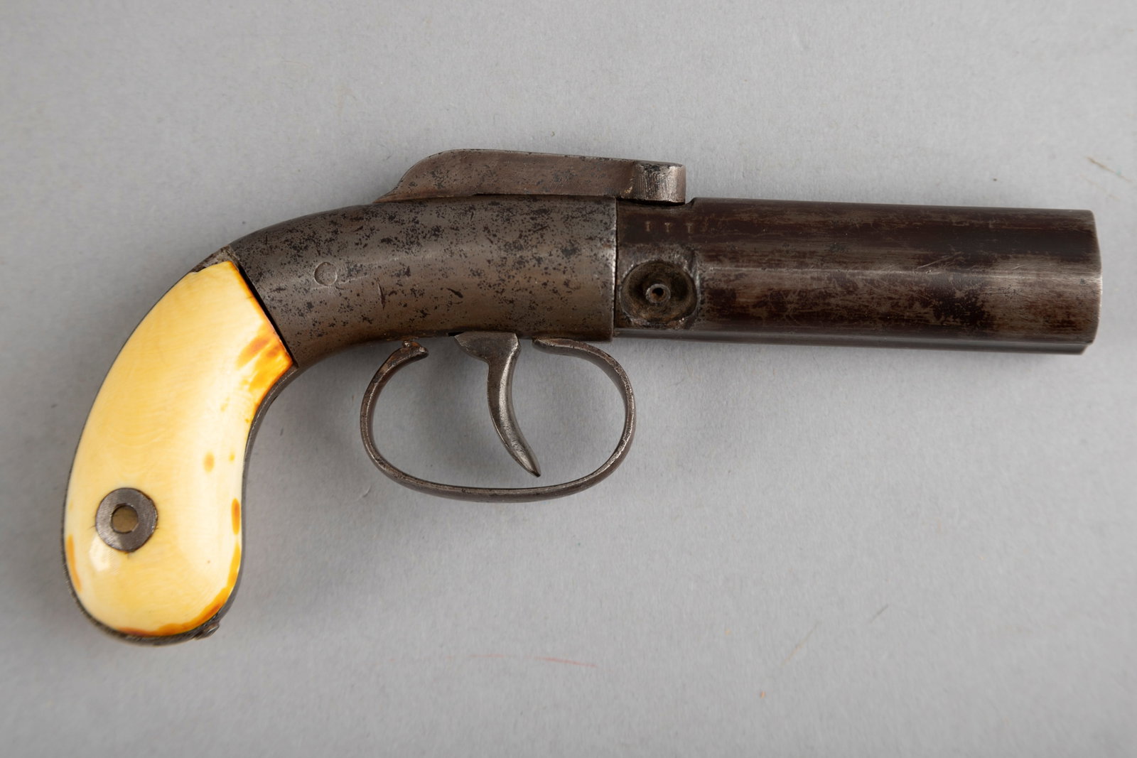 Antique Manhattan three-shot Revolving Pepperbox Pistol, .28 caliber, SN 111, 3" hand turned barrel,: Antique Manhattan three-shot Revolving Pepperbox Pistol, .28 caliber, SN 111, 3" hand turned barrel, light engraving on frame, two-piece ivory grips, finish is dark grey to brown patina, top hammer is