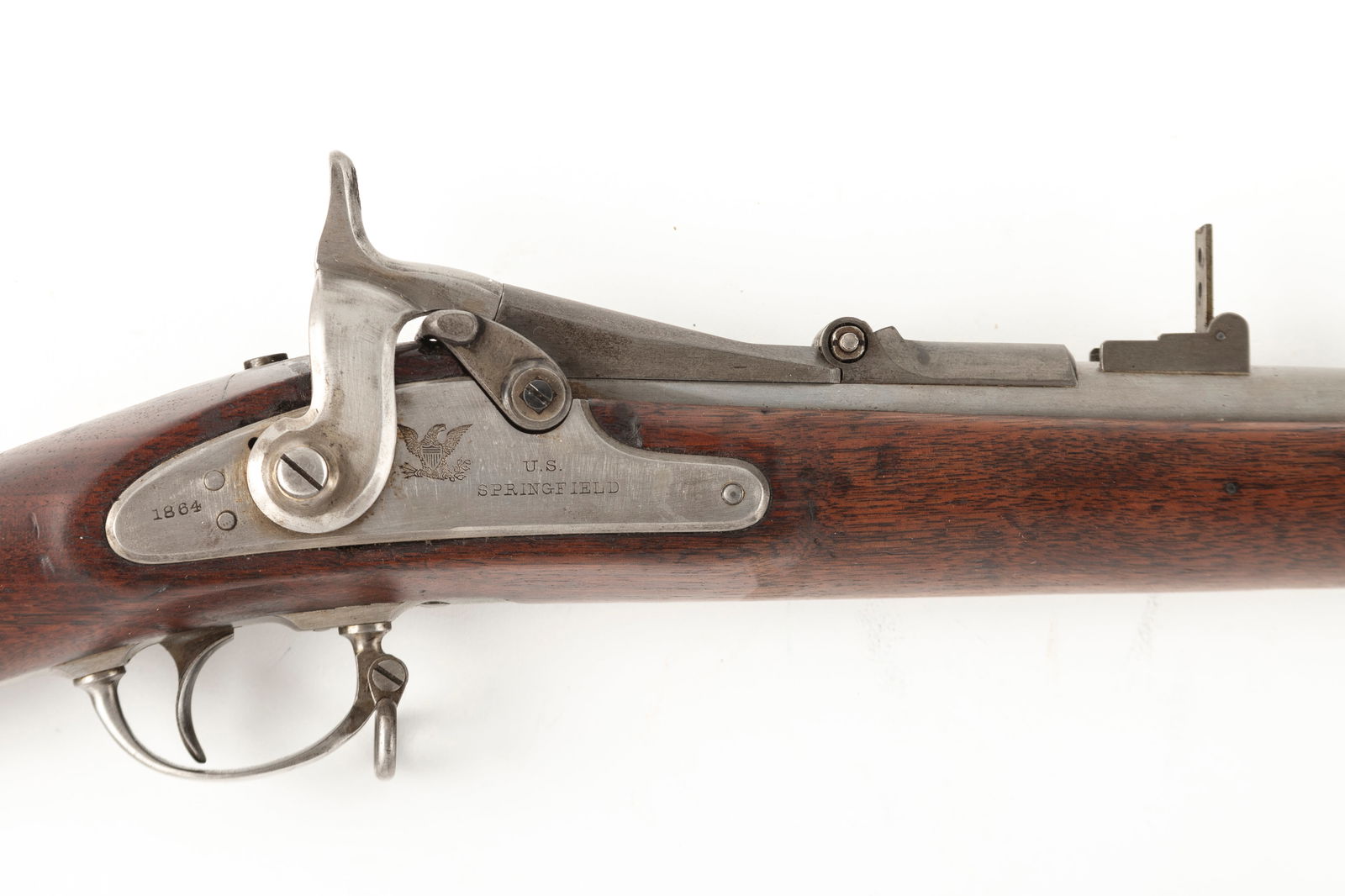 Antique U.S. Springfield Trap Door Rifle, Model 1864, .45/70 caliber, SN NV, 20" round barrel, stock: Antique U.S. Springfield Trap Door Rifle, Model 1864, .45/70 caliber, SN NV, 20" round barrel, stock shows cut away forend with military cartouche on left side. Metal appears to have been cleaned, oth