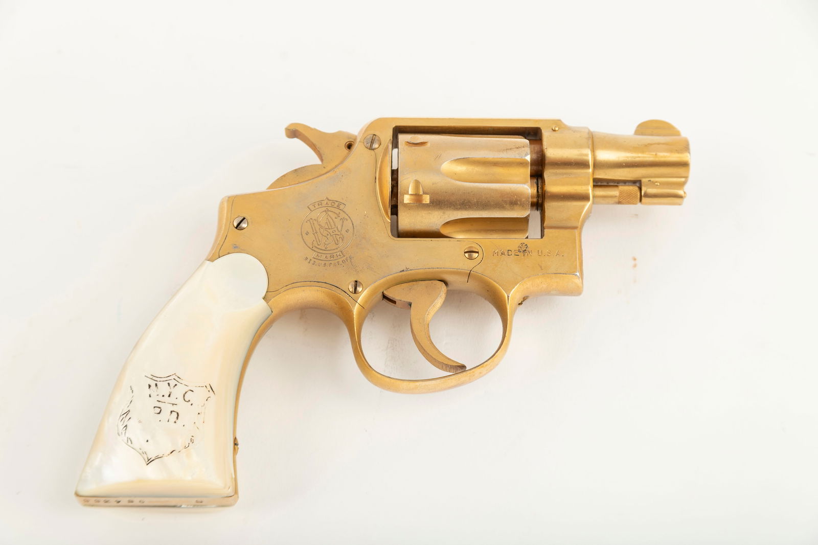Smith and Wesson 38 M&P Post War Pre-Model 10 Revolver, .38 SPL caliber, SN S954355, manufactured in: Smith and Wesson 38 M&P Post War Pre-Model 10 Revolver, .38 SPL caliber, SN S954355, manufactured in 1948, 2" barrel. Early factory original 2" Pre-Model 10 with gold finish and Mother of Pearl grips.