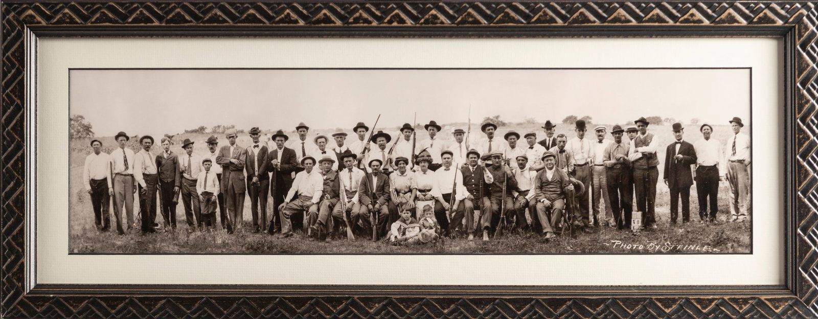 Framed Panoramic of a group of Shooters marked at lower right by San Antonio Photographer "Photo By: Framed Panoramic of a group of Shooters marked at lower right by San Antonio Photographer "Photo By Steinle". NOTE: Most all firearms featured in this panoramic are Winchester Model 12s and Model 97s.
