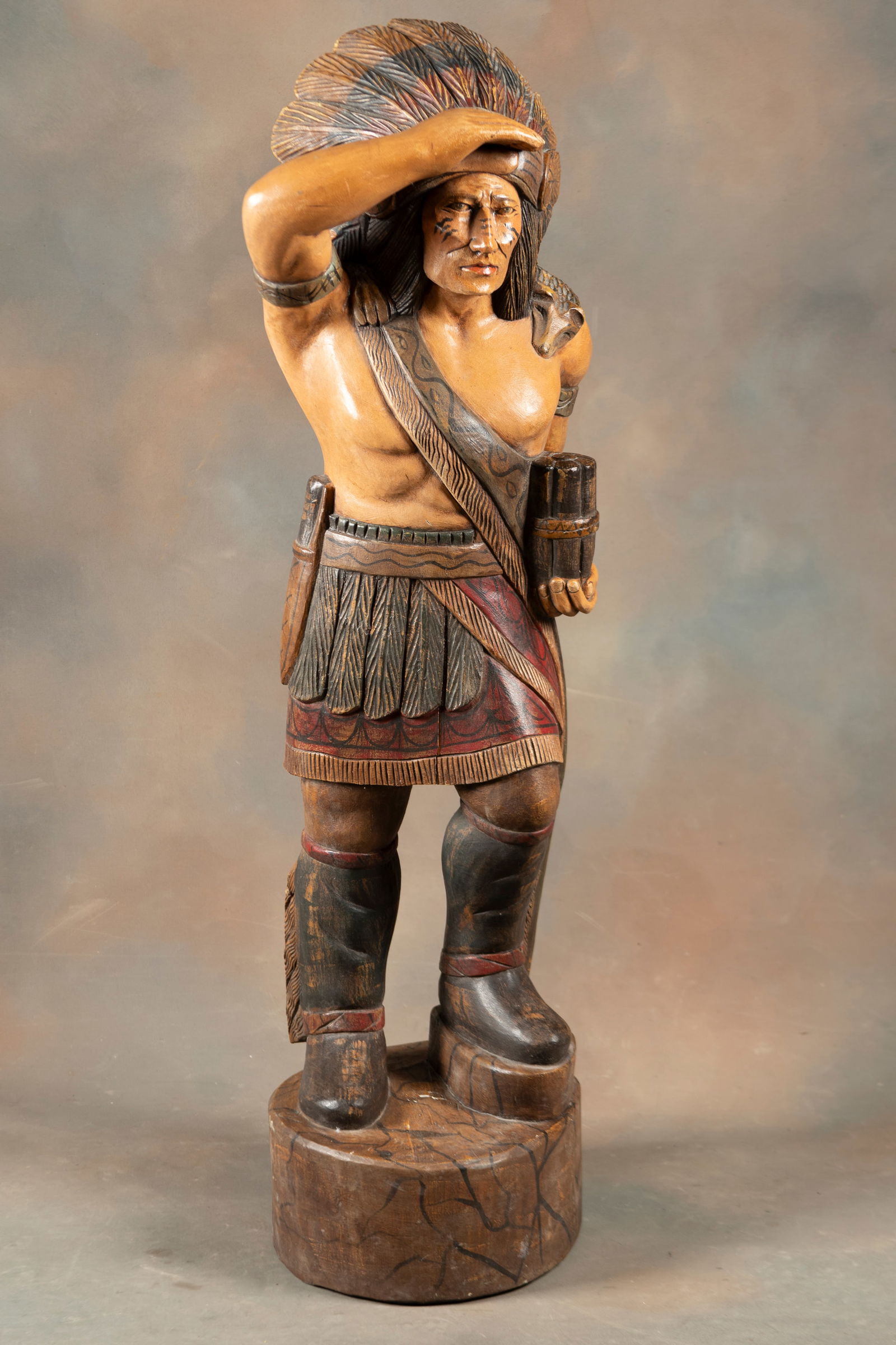 Fully Carved Wooden Cigar Store Indian, very detailed, measures 49" T x 14" dia. base. THE LATE: Fully Carved Wooden Cigar Store Indian, very detailed, measures 49" T x 14" dia. base. THE LATE ROGER MUCKERHEIDE ESTATE.