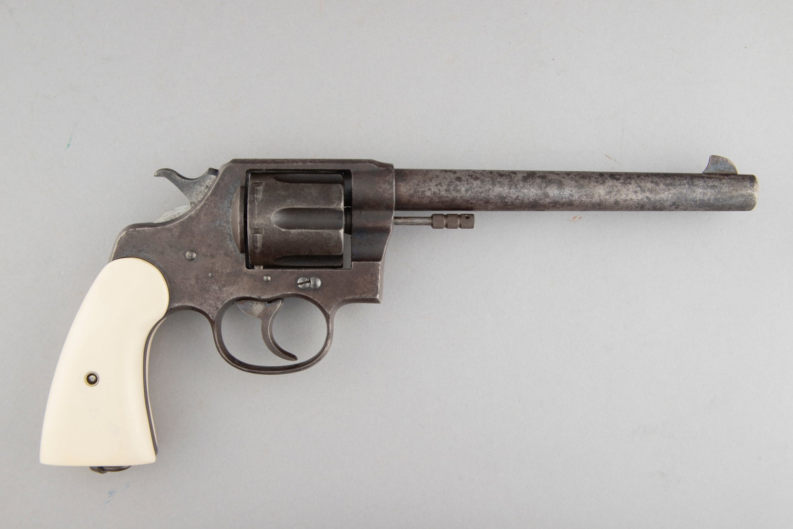 Colt New Service Model Revolver, .45 COLT caliber, SN 25360, manufactured in 1910, 7 1/2" barrel.: Colt New Service Model Revolver, .45 COLT caliber, SN 25360, manufactured in 1910, 7 1/2" barrel. Colt has pitted finish with very little blue left, fitted with polymer grips. (MODERN) THE LATE MICHAE