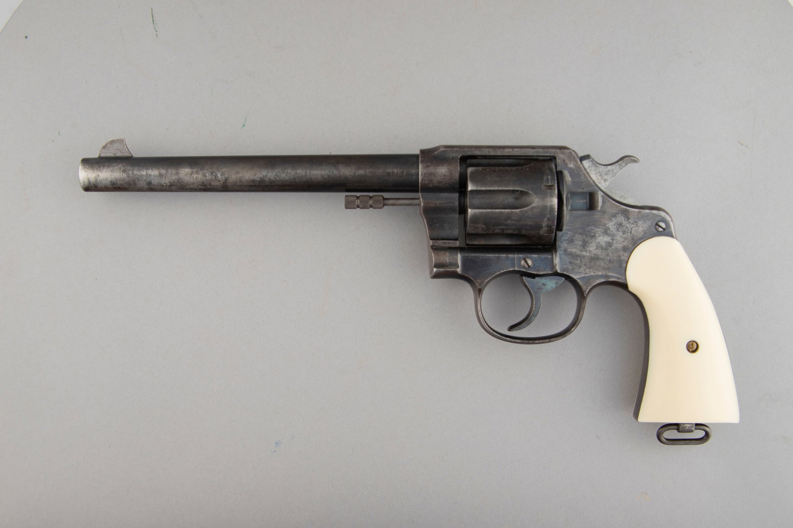 Colt New Service Model Revolver, .45 COLT caliber, SN 57686, 7 1/2" barrel, manufactured in 1942.: Colt New Service Model Revolver, .45 COLT caliber, SN 57686, 7 1/2" barrel, manufactured in 1942. Early Colt with "Stylized C" stamp, has some blue in protected areas otherwise smooth brown patina, fi