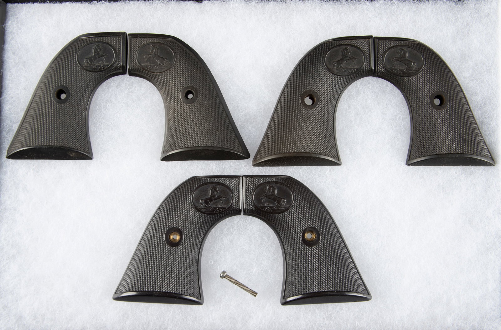 A collection of three pairs of two-piece Grips for Colt SA Revolvers, all three are hard rubber.: A collection of three pairs of two-piece Grips for Colt SA Revolvers, all three are hard rubber. WILL BE SOLD AS ONE LOT.