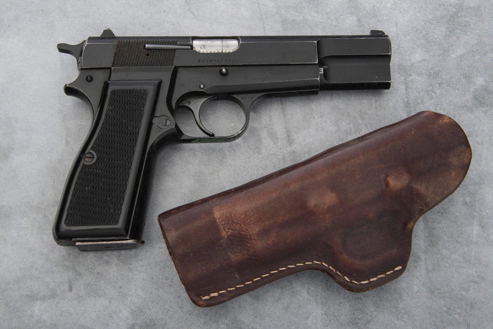 Fabrique Nationale Semi-Auto Pistol, 9x19 caliber, SN 245NY02086, matte finish, 5" barrel, showing: Fabrique Nationale Semi-Auto Pistol, 9x19 caliber, SN 245NY02086, matte finish, 5" barrel, showing some light scratching on slide, overall condition is good, original plastic checkered grips. Sold wit