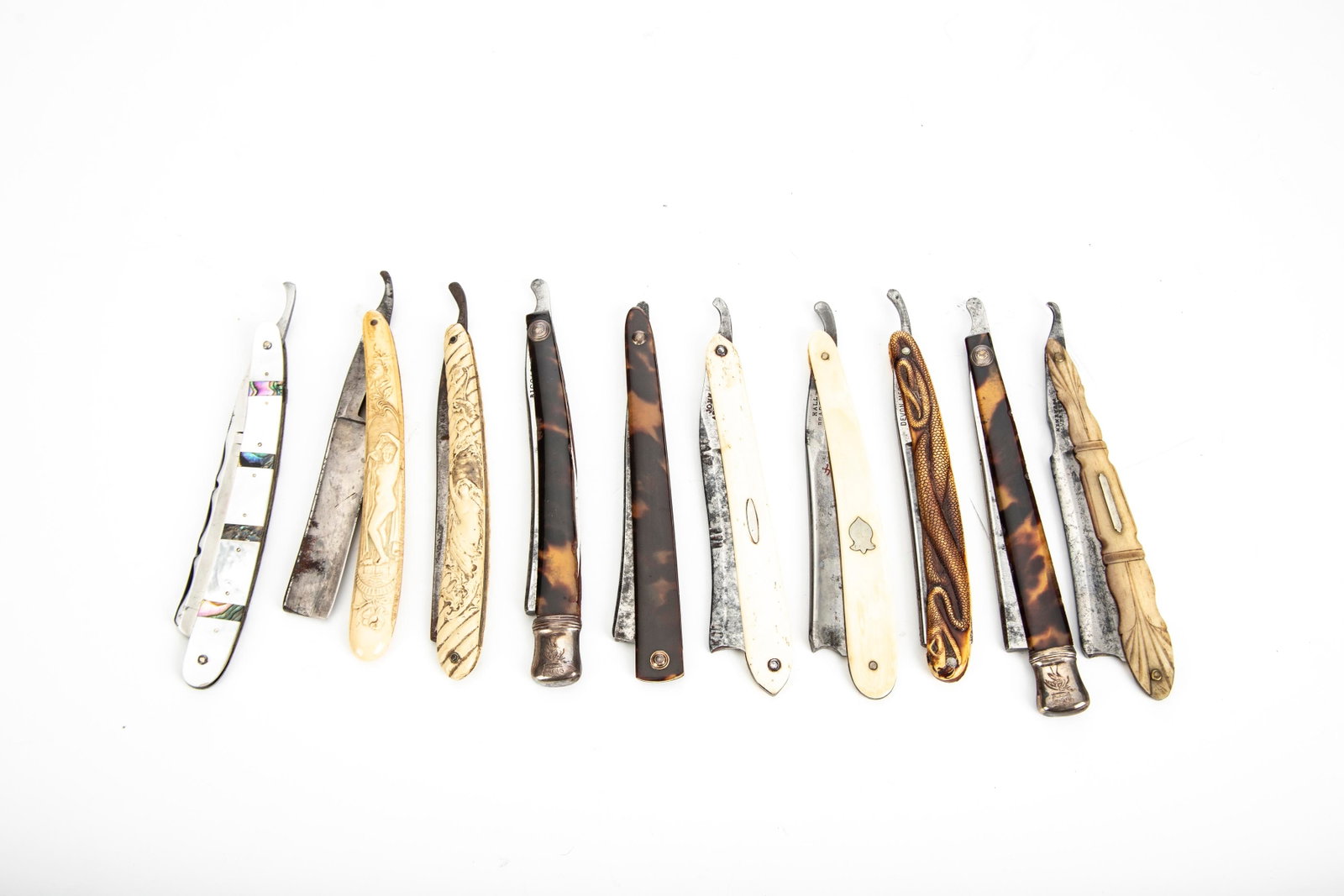 Collection of 10 vintage Straight Razors, many are marked "Germany", some have embossed ladies, one: Collection of 10 vintage Straight Razors, many are marked "Germany", some have embossed ladies, one has a dragon. Will be sold as a collection. THE LATE ROGER MUCKERHEIDE ESTATE.