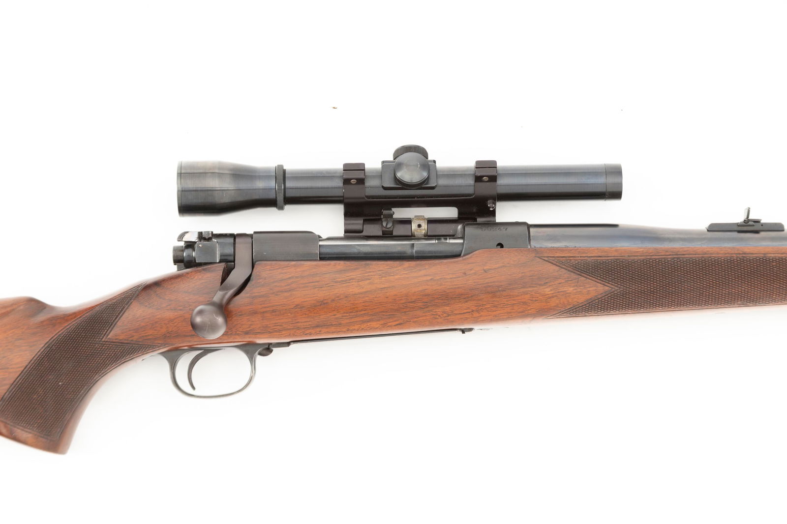 Winchester Model 70 Bolt Action Rifle, .375 MAG caliber, SN 59247, blue finish, 26" barrel with: Winchester Model 70 Bolt Action Rifle, .375 MAG caliber, SN 59247, blue finish, 26" barrel with hooded front sight. Mounted with off-set Leupold Scope. Walnut checkered stock with swivels, 13 1/2" tri