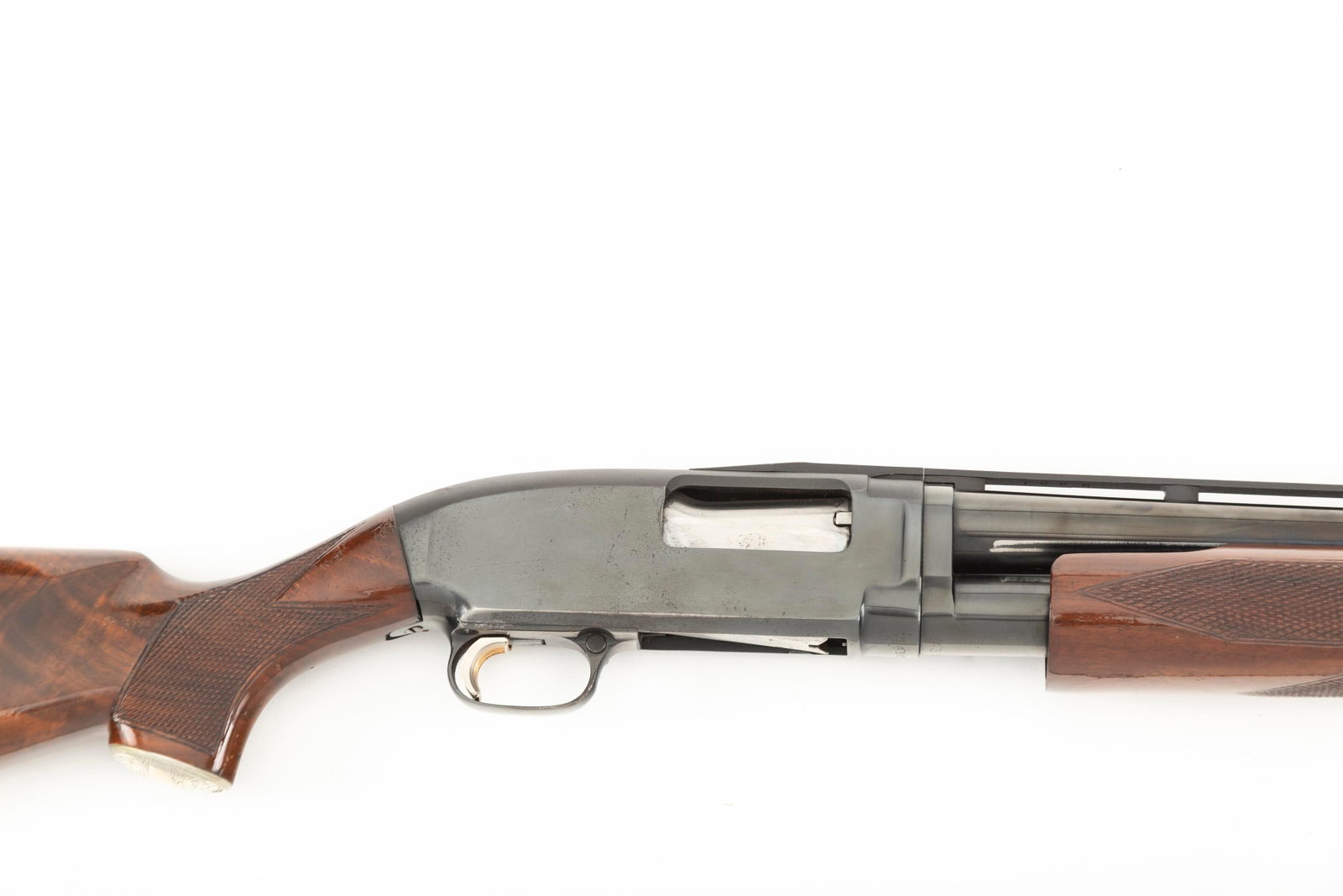 Winchester Model 12 Slide Action Shotgun, 12 ga., SN 1435143, blue finish, 30" raised ported vent: Winchester Model 12 Slide Action Shotgun, 12 ga., SN 1435143, blue finish, 30" raised ported vent barrel, custom trigger, high grade checkered walnut stock. Very good overall condition. (MODERN)