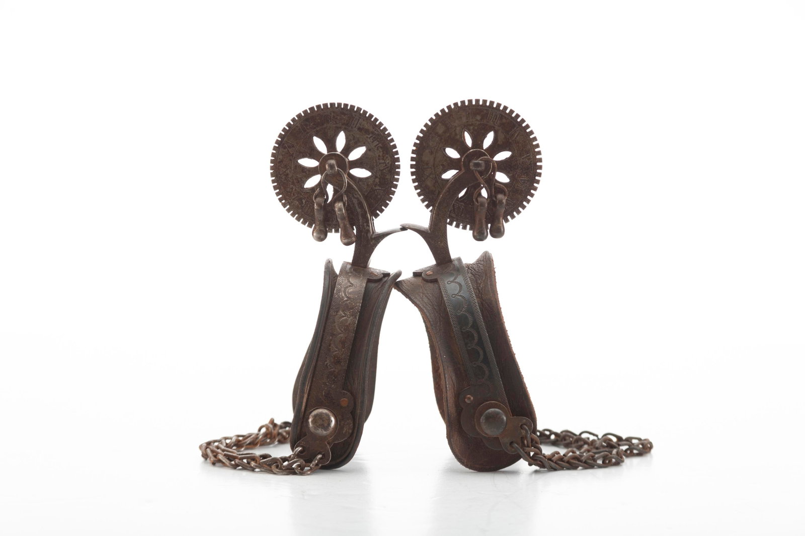 Very desirable Iron Mexican Spurs with lightly engraved heel bands, chap guards, and 2 1/2" clock: Very desirable Iron Mexican Spurs with lightly engraved heel bands, chap guards, and 2 1/2" clock face rowels with jingle bobs. All complete and original with leather liners.