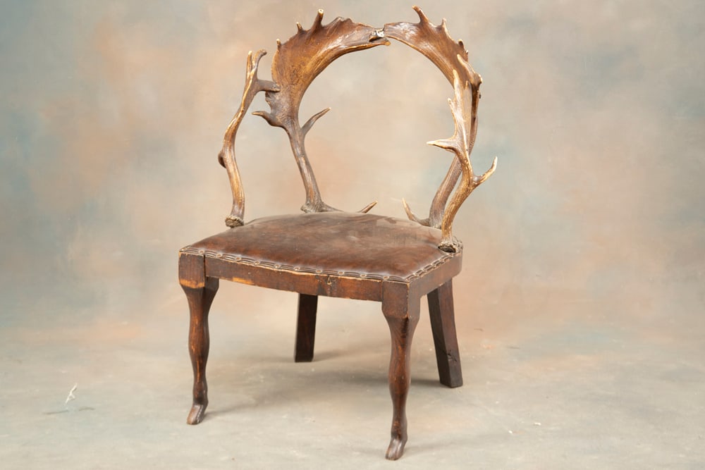 Early wooden and horn Hunting Lodge Chair, possibly made from fallow deer horns. Appears to have: Early wooden and horn Hunting Lodge Chair, possibly made from fallow deer horns. Appears to have original fabric, measures 3 ft. tall at back, 21" W seat. Wood portion remains in original finish. Fron