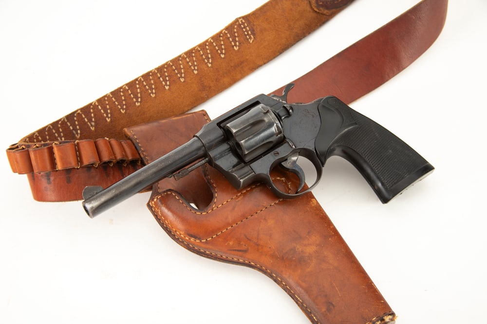 Colt Official Police Double Action Revolver, .38 SPL caliber, SN 829225, blue finish, 4 3/4" barrel,: Colt Official Police Double Action Revolver, .38 SPL caliber, SN 829225, blue finish, 4 3/4" barrel, nice overall condition with some light thinning at muzzle area, and fine turn line. Custom Pachmayr