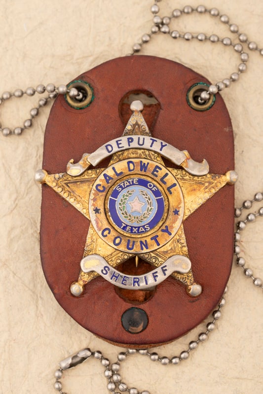 “DEPUTY/ CALDWELL COUNTY/ SHERIFF?? marked 5-point Ball Star Badge with two tone blue raised: “DEPUTY/ CALDWELL COUNTY/ SHERIFF” marked 5-point Ball Star Badge with two tone blue raised porcelain “State of Texas” center Seal, marked "Don Perry" with neck chain and leather case,