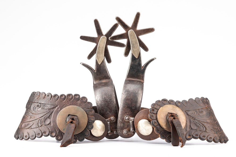 Pair of "Kelly Bros." marked single mounted Spurs in the famous Bronc Buster pattern, 1 1/8" heel: Pair of "Kelly Bros." marked single mounted Spurs in the famous Bronc Buster pattern, 1 1/8" heel bands with chap guards. Marked "Kelly Bros. under swing buttons. These Spurs were made between 1920-19