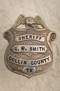 Beautiful Shield Badge with Eagle Crest marked “SHERIFF/ G.W. SMITH/ COLLIN COUNTY/ TX??, Smith: Beautiful Shield Badge with Eagle Crest marked “SHERIFF/ G.W. SMITH/ COLLIN COUNTY/ TX”, Smith was Sheriff 1972-1974. Badge measures 2 1/8” T x 1 7/8” W with replaced pin and