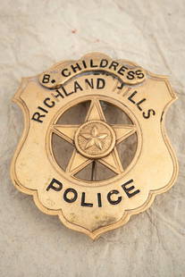 Gold tone Shield Badge with cut-out 5-point Star, measures 2 1/8?? T x 1 ¾?? W, marked: Gold tone Shield Badge with cut-out 5-point Star, measures 2 1/8” T x 1 ¾” W, marked “RICHLAND HILLS POLICE” with applied panel marked “B. CHILDRESS”, has flat bar