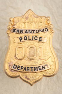 Large gold tone Shield Badge marked “SAN ANTONIO POLICE DEPT/ # 001??, measures 3?? T x 2 1/8: Large gold tone Shield Badge marked “SAN ANTONIO POLICE DEPT/ # 001”, measures 3” T x 2 1/8” W, with flat bar pin and catch. THE LATE DON PERRY ESTATE.