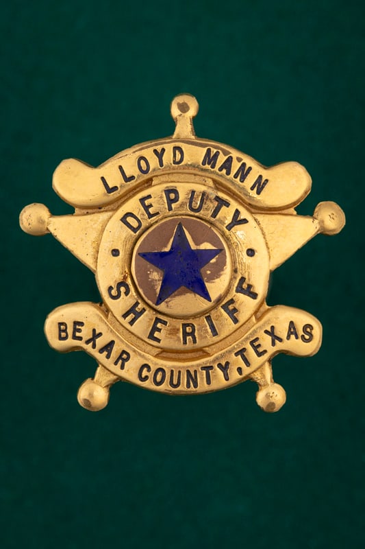 “LLOYD MANN / DEPUTY SHERIFF / BEXAR COUNTY, TEXAS?? 5-point Ball Star Badge, with panels, black: “LLOYD MANN / DEPUTY SHERIFF / BEXAR COUNTY, TEXAS” 5-point Ball Star Badge, with panels, black enamel lettering and star for center Seal. Badge measures 1 5/8” T x 1 5/8” W with p