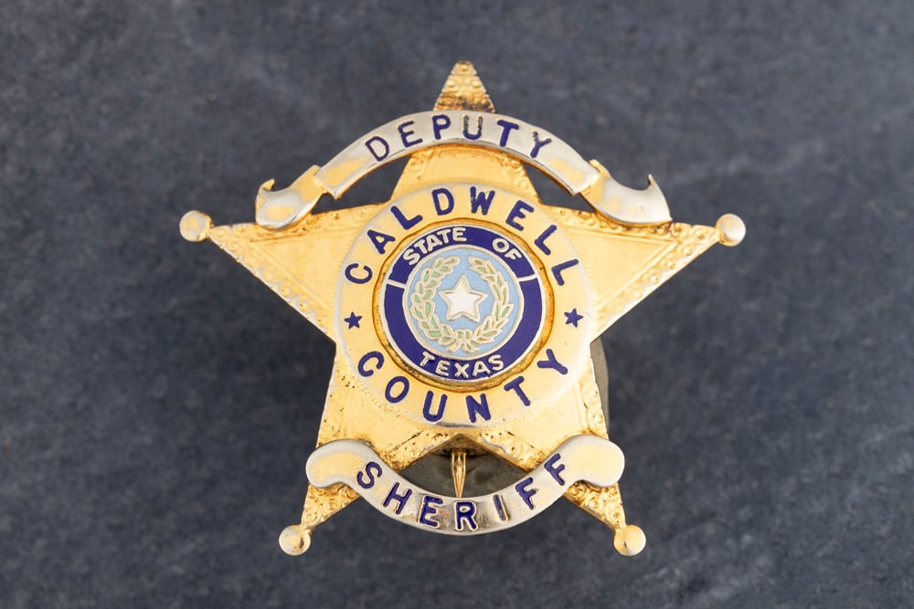 “DEPUTY / CALDWELL COUNTY/ SHERIFF?? marked 5-point Ball Star Badge, ball at top of star is: “DEPUTY / CALDWELL COUNTY/ SHERIFF” marked 5-point Ball Star Badge, ball at top of star is missing. Gold tone with two silver tone banners and two tone blue enamel “State of Texas” cen