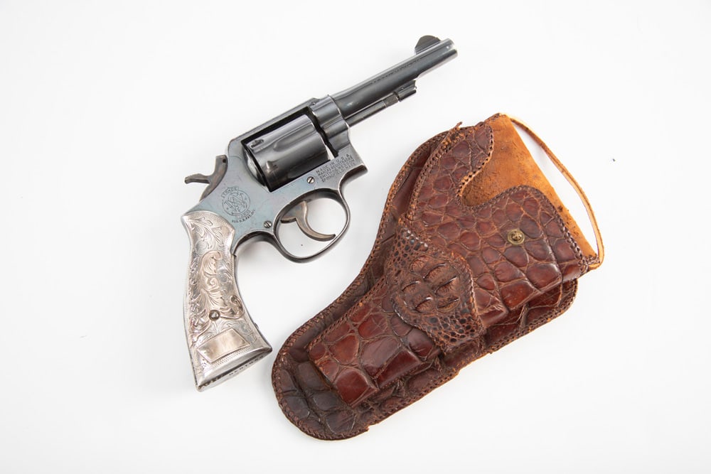 Smith & Wesson, Model 10-5 DA Revolver, .38 S&W SPL caliber, SN C901030, blue finish, 4" barrel,: Smith & Wesson, Model 10-5 DA Revolver, .38 S&W SPL caliber, SN C901030, blue finish, 4" barrel, showing some handling marks and light turn line. Revolver is mounted with beautiful silver engraved two