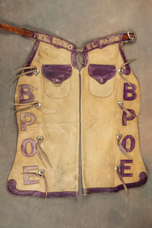 Vintage "S.D. Myres" marked bull hide two-tone Rodeo Show Chaps marked "El Paso" on Belt and: Vintage "S.D. Myres" marked bull hide two-tone Rodeo Show Chaps marked "El Paso" on Belt and initials "BPOE" that flank the outside border with nickel heart buttons, outside pockets. Chaps are in very