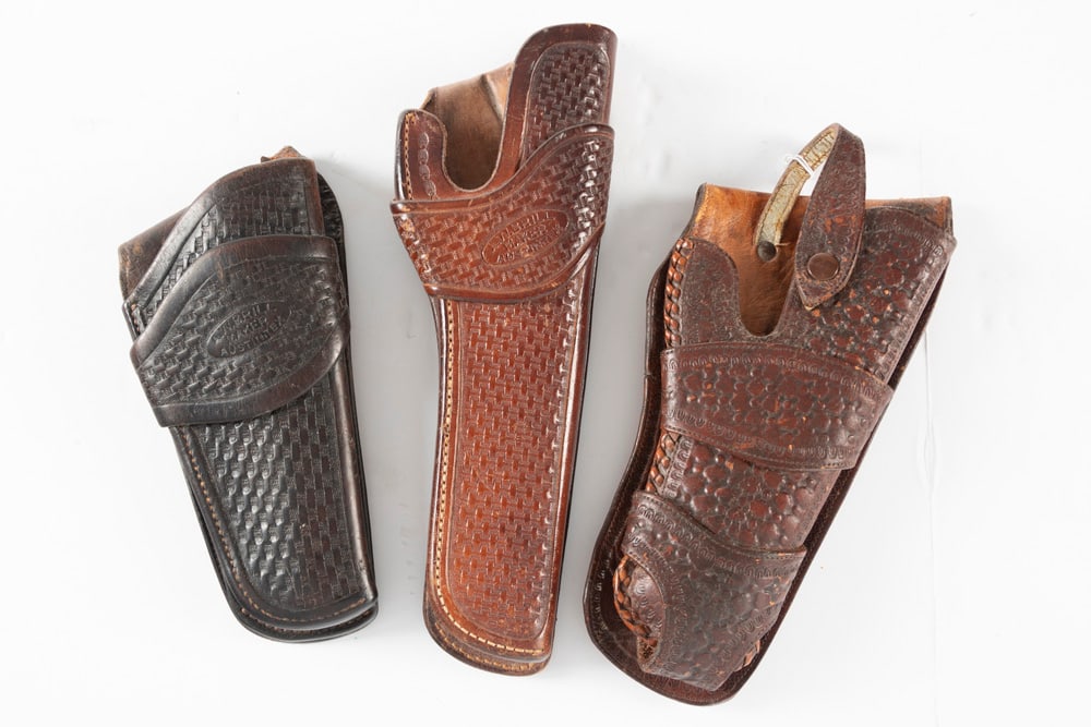 Collection of three (3) Leather Holsters. Two are basket weave pattern marked "A.W. Brill / Austin,: Collection of three (3) Leather Holsters. Two are basket weave pattern marked "A.W. Brill / Austin, Texas". One for an automatic or for a revolver. The third is a jockey strap style for a 1911 Pistol,