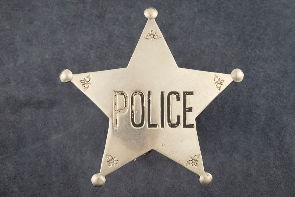 Silver tone 5-point ball tipped Stock Police Star Badge, measures 2 ¾?? T x 2 5/8?? W, with: Silver tone 5-point ball tipped Stock Police Star Badge, measures 2 ¾” T x 2 5/8” W, with saddle pin and catch. THE LATE DON PERRY ESTATE.