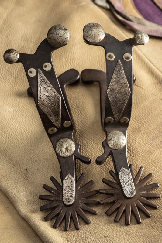 Scarce inside marked "Crockett" single mounted Spurs in the Pendleton pattern, split heel bands with: Scarce inside marked "Crockett" single mounted Spurs in the Pendleton pattern, split heel bands with double buttons and chap guards. Very desirable. THE LATE OTIS HIBLER ESTATE.