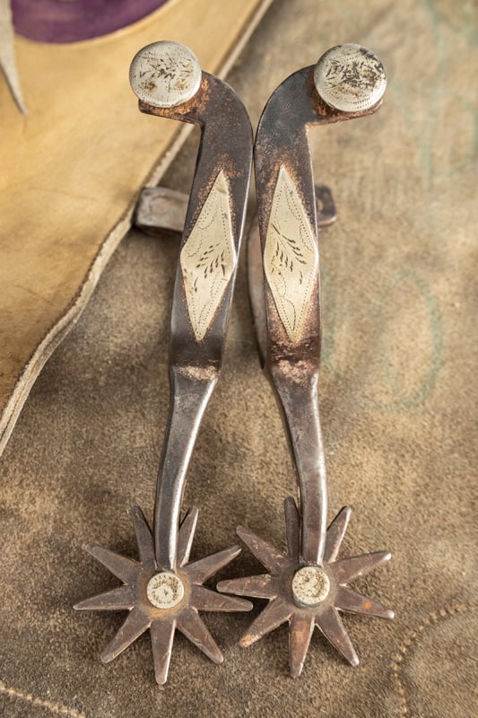 Pair of "Kelly Bros. & Parker" single mounted Spurs with scarce mark being fully spelled out, large: Pair of "Kelly Bros. & Parker" single mounted Spurs with scarce mark being fully spelled out, large multi-point rowels and etched fixed buttons. THE LATE OTIS HIBLER ESTATE.