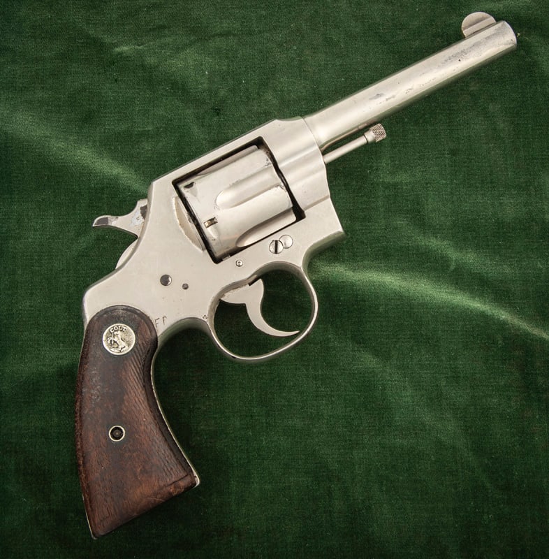 Colt Official Police DA Revolver, .38 caliber, SN 5577, factory nickel finish, 4 3/4" barrel,: Colt Official Police DA Revolver, .38 caliber, SN 5577, factory nickel finish, 4 3/4" barrel, retains majority of its original nickel, some light muzzle wear, original checkered grips with Colt Medall