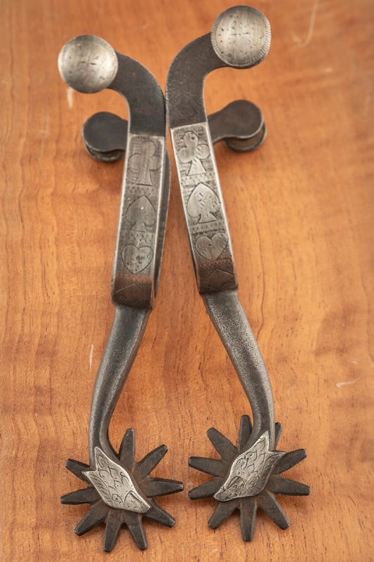 Early McChesney double mounted Spurs, pattern #44, with eagle head shanks, engraved card suits on: Early McChesney double mounted Spurs, pattern #44, with eagle head shanks, engraved card suits on heel bands, circa 1920s. THE LATE OTIS HIBLER ESTATE.