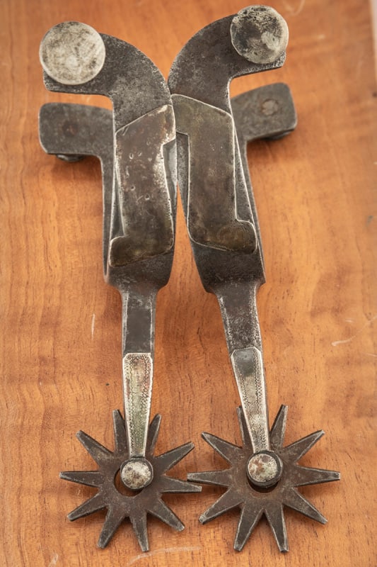 "Kelly Bros." marked double mounted Spurs, pattern #30, style #2, with scroll pattern on one heel: "Kelly Bros." marked double mounted Spurs, pattern #30, style #2, with scroll pattern on one heel band and diamond on opposite heel band. NOTE: Rowels show much use. THE LATE OTIS HIBLER ESTATE.