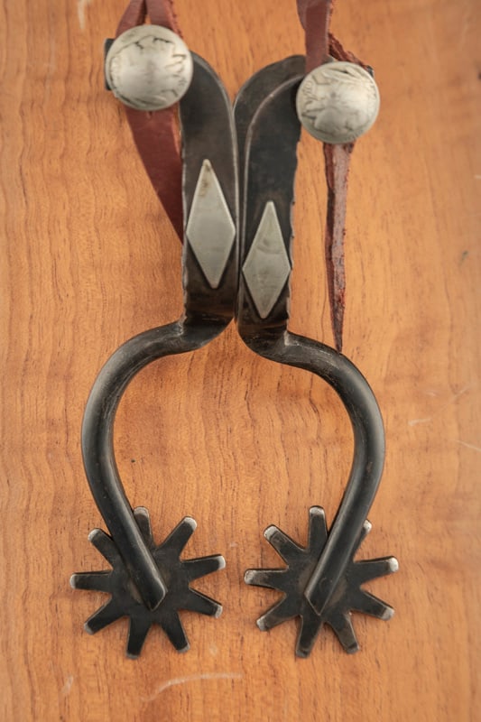 Pair of "Greenlee" marked, single mounted Spurs, one-piece with Marfa style shanks, well-marked with: Pair of "Greenlee" marked, single mounted Spurs, one-piece with Marfa style shanks, well-marked with buffalo head nickel fixed buttons. Ron Greenlee, 1943-2016, Jones, Oklahoma Bit & Spur Maker. THE L