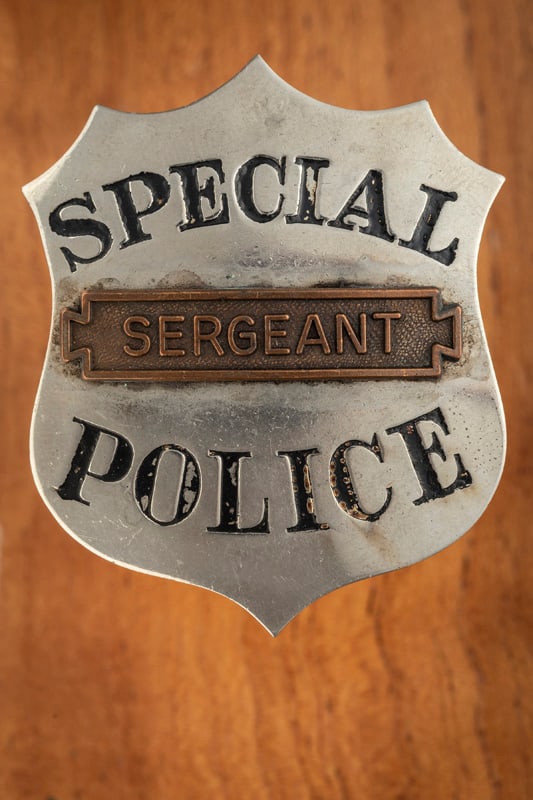 Stock silver tone “SPECIAL POLICE?? marked Badge with applied banner in center marked: Stock silver tone “SPECIAL POLICE” marked Badge with applied banner in center marked “SERGEANT” which appears to have been added at a later date. Badge measures 2 1/8” T x 1 &fra