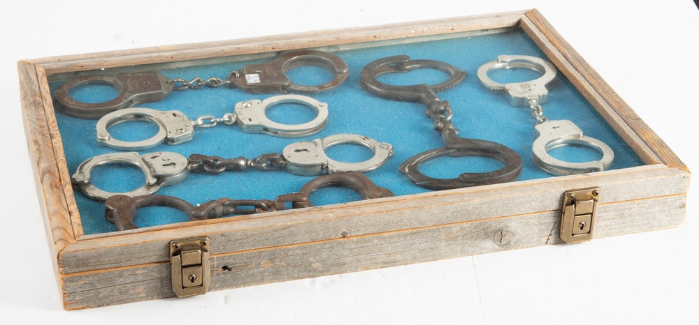 This lot consists of a Collection of six (6) vintage Law Enforcement Wrist Restraints to include:: This lot consists of a Collection of six (6) vintage Law Enforcement Wrist Restraints to include: (1) One pair marked "Strauss Eng. Co., Crawford, GA." (2) A pair of "Smith & Wesson, Houlton, ME. SN G