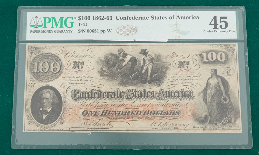 $100.00 Confederate Note professionally graded, choice & extremely fine, encased for protection.: $100.00 Confederate Note professionally graded, choice & extremely fine, encased for protection. This historic Note is dated December 1, 1862 and shows three slaves in the center of the note working i