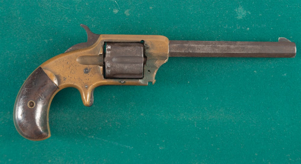 Antique Whitneyville SA Revolver, .32 RIMFIRE caliber, SN 1029, brass frame with all metal dark: Antique Whitneyville SA Revolver, .32 RIMFIRE caliber, SN 1029, brass frame with all metal dark brown patina, two-piece bird beak grips, missing part of the cylinder pin, sold in as is condition. THE 