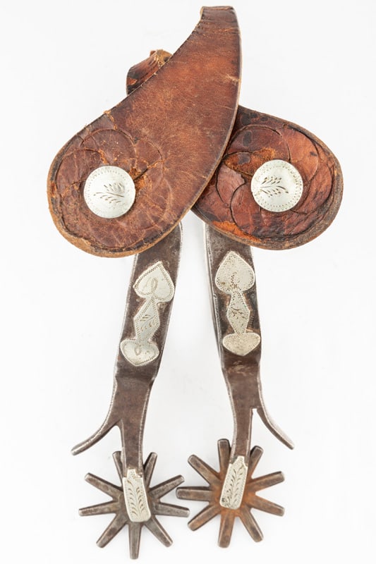 Pair of "KB&P" marked, single mounted Spurs, Pattern #14, 1912-1919, engraved spades on heel bands: Pair of "KB&P" marked, single mounted Spurs, Pattern #14, 1912-1919, engraved spades on heel bands with chap guards. Mounted with very fragile straps, one strap is broken. THE BUDDY KING COLLECTION.