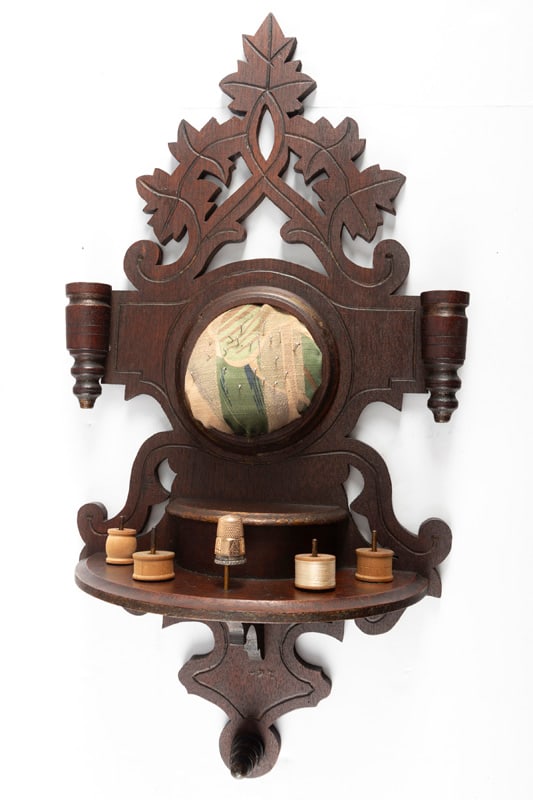 Victorian walnut wall hanging Pin Cushion, circa 1880s, in original finish, measures 19" L x 9" W at: Victorian walnut wall hanging Pin Cushion, circa 1880s, in original finish, measures 19" L x 9" W at widest point. This Victorian piece will be accompanied by 6 thimbles, one is gold plated the others