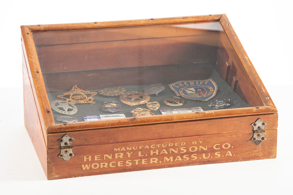 This lot consists of a collection of eleven (11) Badges, two (2) ID Cards, two (2) Patch's and one: This lot consists of a collection of eleven (11) Badges, two (2) ID Cards, two (2) Patch's and one (1) Tin Sign to include: (1) Silver tone Circle Badge with applied 5-point Ball Star Badge, measures 