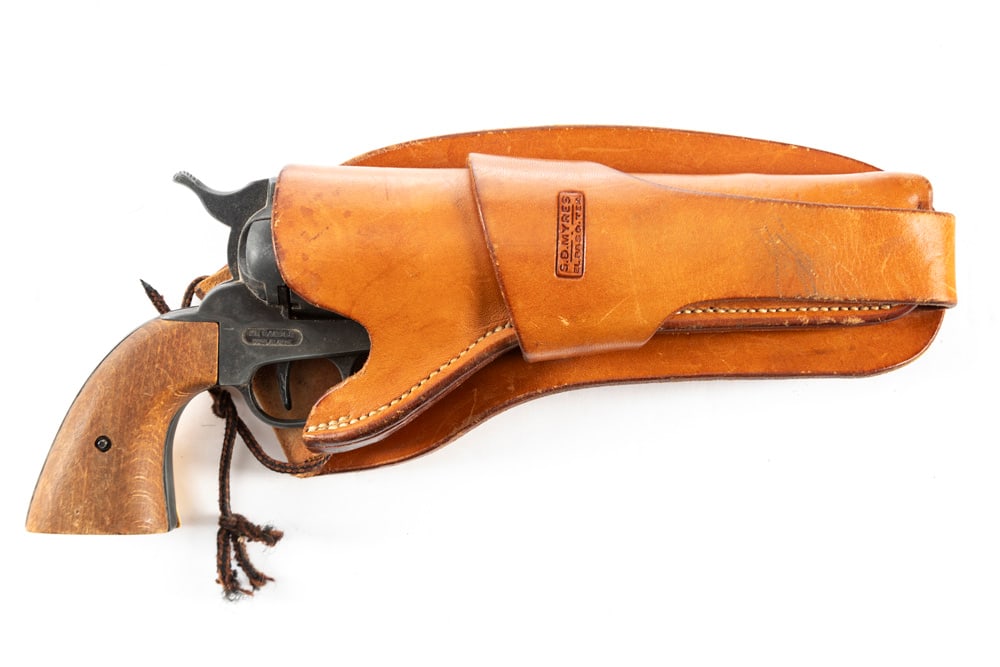 Single Loop Holster for a 7 1/2" SA revolver, marked "S.D. Myres, El Paso, Tex," very good: Single Loop Holster for a 7 1/2" SA revolver, marked "S.D. Myres, El Paso, Tex," very good condition. Holster is accompanied by a Hollywood style Prop Revolver with mismatched grips. WILL BE SOLD AS O