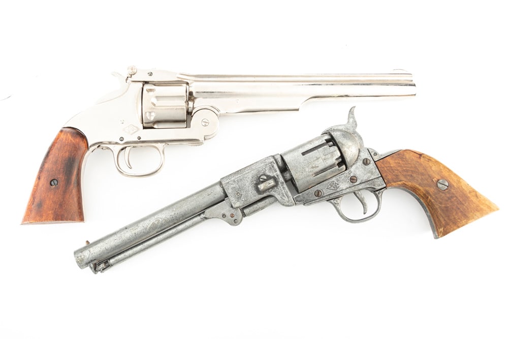 This lot consists of two Hollywood Style Prop Gun Revolvers. One is fashioned after an early Smith &: This lot consists of two Hollywood Style Prop Gun Revolvers. One is fashioned after an early Smith & Wesson. The other after an 1860 Army. These two non-firing Prop Guns WILL SELL AS ONE LOT. THE LATE