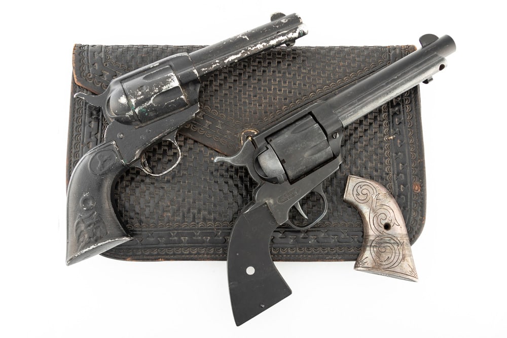 This lot consists of two Hollywood Style Prop Gun Revolvers. They are fashioned after Colt SA: This lot consists of two Hollywood Style Prop Gun Revolvers. They are fashioned after Colt SA Revolvers with 4 3/4" barrels. One has silver grip with right hand grip missing. These two prop guns will 