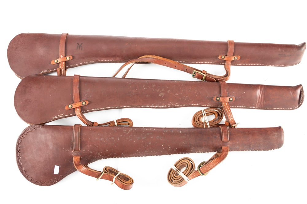 A collection of three heavy leather Saddle Scabbards. One is for a Winchester 1894 Carbine. The: A collection of three heavy leather Saddle Scabbards. One is for a Winchester 1894 Carbine. The other two were made for Rifles. Good original condition with original leather Saddle Straps. WILL BE SOL