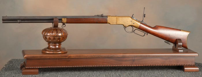 Custom fitted walnut Rifle Display Stand with fancy beaded trim, 40" long x 8" wide. Stand will