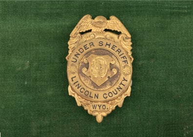 Vintage gold tone Shield Badge with winged eagle crest marked "Under Sheriff/Lincoln County/Wyo."