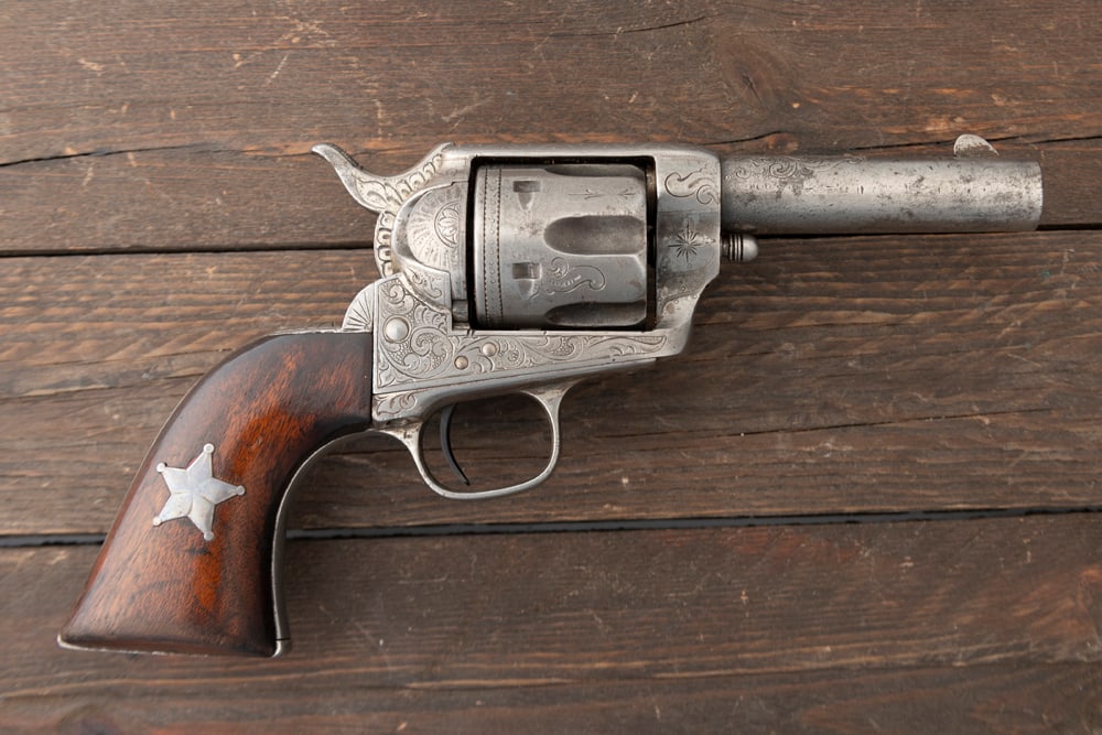 Antique engraved Colt SAA, SN 62402, converted into a Sheriffs Model. Colt Single ActionArmy 6-shot: Antique engraved Colt SAA, SN 62402, converted into a Sheriffs Model. Colt Single ActionArmy 6-shot Revolver in .45 caliber with a 3 3/4” barrel manufactured in 1881. The serial numbers matchon 